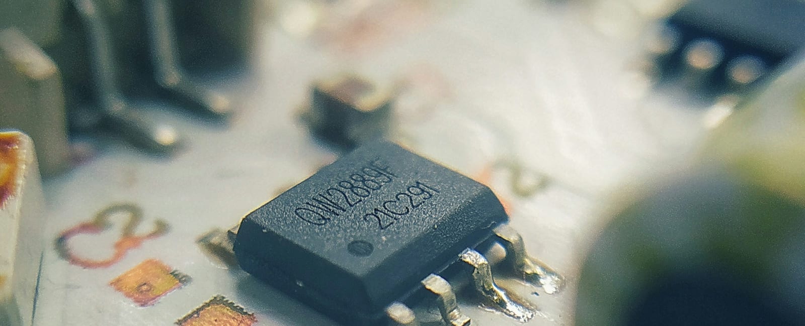 A microchip on a circuit board, photographed close up.