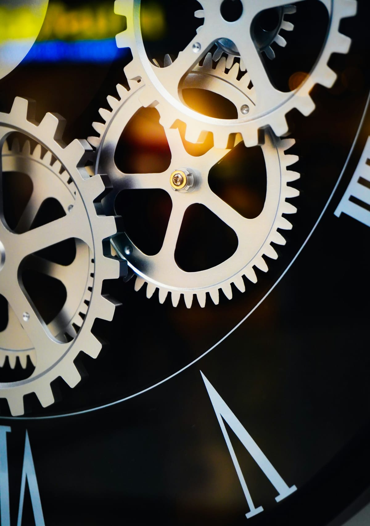 Clockwork gears behind a clock face.