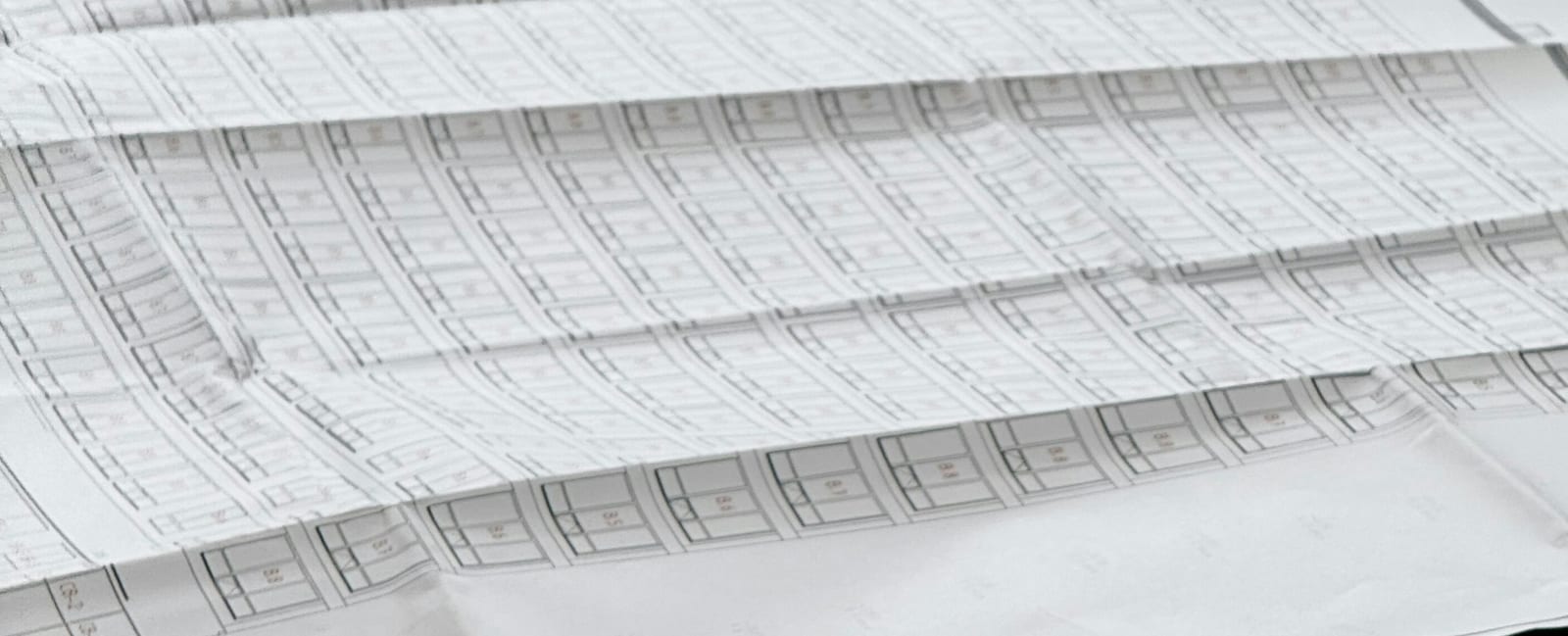 Architectural blueprints spread across a table.